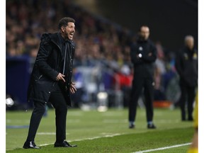 Atletico Madrid's head coach Diego Simeone shouts to his players from the sidelines during the Group A Champions League soccer match between Atletico Madrid and Borussia Dortmund at the Wanda Metropolitano stadium in Madrid, Spain, Tuesday, Nov. 6, 2018.