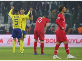 Sweden's Martin Olsson and Sweden's Marcus Berg, left, celebrate their victory after the UEFA Nations League soccer match between Turkey and Sweden in Konya, Turkey, Saturday, Nov. 17, 2018.