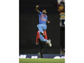 India's Khaleel Ahmed celebrates after he got the wicket of Australia's D'Arcy Short, not shown, during the first T20 International cricket match between Australia and India in Brisbane, Australia, Wednesday, Nov. 21, 2018.