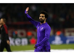 Liverpool forward Mohamed Salah waves to their fans before the Champions League group C soccer match between Red Star and Liverpool at the stadium Rajko Mitic in Belgrade, Tuesday, Nov. 6, 2018.