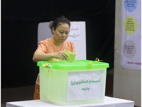 A voter casts her ballot at a polling station in Yangon, Myanmar, Saturday, Nov. 3, 2018. Myanmar staged by-elections Saturday in 13 constituencies, a few for the national parliament, the rest at the state or regional levels.