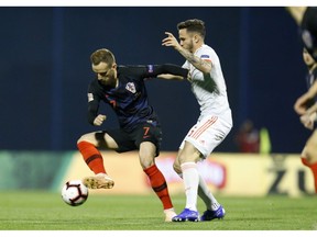 Croatia's Ivan Rakitic, left, challenges for the ball with with Spain's Saul Niguez during the UEFA Nations League soccer match between Croatia and Spain at the Maksimir stadium in Zagreb, Croatia, Thursday, Nov. 15, 2018.
