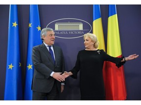 European Parliament President Antonio Tajani, left, shakes hands with Romanian Prime Minister Viorica Dancila at the Victoria Palace in Bucharest, Romania, Wednesday, Nov. 21, 2018.