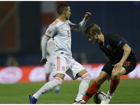 Spain's Paco Alcacer, left, challenges for the ball with Croatia's Tin Jedvaj during the UEFA Nations League soccer match between Croatia and Spain at the Maksimir stadium in Zagreb, Croatia, Thursday, Nov. 15, 2018.