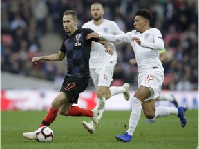 England's Jadon Sancho, right, challenges for the ball with Croatia's Marko Rog during the UEFA Nations League soccer match between England and Croatia at Wembley stadium in London, Sunday, Nov. 18, 2018.