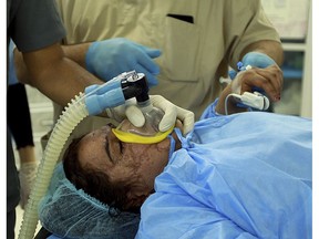 In this Tuesday, Nov. 6, 2018 photo, Saja Ahmed Saleem, is seen in the operating room for her reconstructive surgery, in Baghdad, Iraq. Those whom treatment not available at state-run hospitals and can't afford treatment at private clinics rely on social media to make appeals that grab attention of some surgeons to help them regain a chance at life.