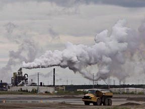 A dump truck works near the Syncrude oil sands extraction facility near the city of Fort McMurray, Alta., on June 1, 2014.