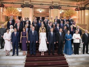 Japan's Prime Minister Shinzo Abe and his wife Akie, U.S. President Donald Trump with his wife Melania, Argentina's President Mauricio Macri with his wife Juliana Awada, China's President Xi Jinping with his wife Peng Liyuan, Germany's Chancellor Angela Merkel, and Russia's President Vladimir Putin (L-R 1st row), India's Prime Minister Narendra Modi, Turkey's President Recep Tayyip Erdogan with his wife Emine, France's President Emmanuel Macron with his wife Brigitte, Prime Minister Mark Rutte of the Netherlands, Canada's Prime Minister Justin Trudeau with his wife Sophie Gregoire Trudeau, Britain's Prime Minister Theresa May, and Brazil's President Michel Temer (L-R 2nd row) pose for a photo at a reception at the Colon Theatre during the G20 Summit in Buenos Aires, Argentina.