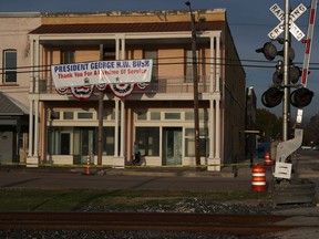 A sign hangs from a building next to the rail lines where Union Pacific No. 4141 will be bearing the coffin of President George H.W. Bush on December 05, 2018 in Navasota, Texas.