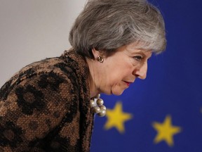 British Prime Minister Theresa May walks by the EU stars as she arrives for a media conference at an EU summit in Brussels, Friday, Dec. 14, 2018.