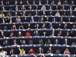 Members of the European Parliament take part in a vote during a plenary session  at the European Parliament on December 11, 2018 in Strasbourg, eastern France.