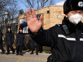 Chinese police patrol in front of the Canadian embassy in Beijing on December 14, 2018.
