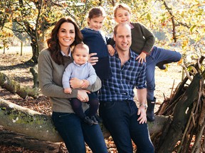 A handout picture released by Kensington Palace on December 14, 2018 shows Britain's Prince William, Duke of Cambridge and Britain's Catherine, Duchess of Cambridge, and their three children Prince Louis of Cambridge (second left), Princess Charlotte of Cambridge (centre) and Prince George of Cambridge (right) posing for a photograph at Anmer Hall in Norfolk in the Autumn of 2018.