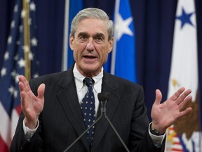 In this file photo taken on August 1, 2013, former Federal Bureau of Investigation (FBI) Director Robert Mueller speaks during a farewell ceremony in his honour at the Department of Justice.