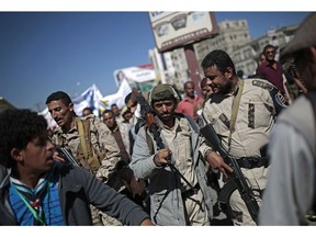 Houthi fighters take part in a protest calling for the reopening of Sanaa airport to receive medical aid, in front of the U.N. offices in Sanaa, Yemen, Monday, Dec. 10, 2018.