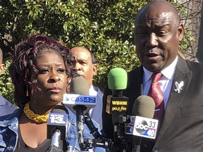 April Pipkins and her family's lawyer, Ben Crump, hold a news conference in Birmingham, Ala., on Monday, Dec. 17, 2018. Pipkins, the mother of a black man who was shot to death by a police officer in an Alabama shopping mall on Thanksgiving, criticized the state's decision to take over an investigation of the case. Emantic "EJ" Bradford Jr. was fatally wounded after an officer saw him with a gun, authorities said.