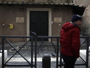 A man stands outside a first aid station in St. Peter's Square at the Vatican , Saturday, Dec. 22, 2018. The pope's official almsgiver has opened a health station beneath St. Peter's Square to serve the homeless, expanding Pope Francis' efforts to care for the needy living close to the heart of the Roman Catholic Church.