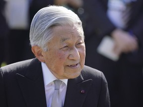 FILE - In this Wednesday, April 25, 2018 file photo, Japan's Emperor Akihito greets the guests during the spring garden party at the Akasaka Palace imperial garden in Tokyo.  Japan's Emperor Akihito, marking his 85th birthday -- his last before his upcoming abdication -- said he feels relieved that his reign is coming to an end without having seen his country at war and that it is important to keep telling younger people about his nation's wartime history, it was reported on Saturday, Dec. 22, 2018.