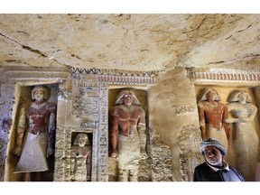 Saeed Abdel Aal, an excavation worker stands at the recently uncovered tomb of the Priest royal Purification during the reign of King Nefer Ir-Ka-Re, named "Wahtye", at the site of the step pyramid of Saqqara, in Giza, Egypt, Saturday, Dec. 15, 2018. The Egyptian Archaeological Mission working at the Sacred Animal Necropolis in Saqqara archaeological site succeeded to uncover the tomb, Antiquities Minister Khaled el-Anani, announced.