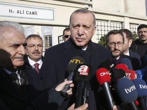 Turkey's President Recep Tayyip Erdogan speaks to journalists after Friday prayers, in Istanbul, Friday, Dec. 28, 2018. Erdogan says the facts on the ground in a key northern Syrian town remain uncertain but he emphasised Turkey's goal of ousting a Kurdish militant group. (Presidential Press Service via AP, Pool)