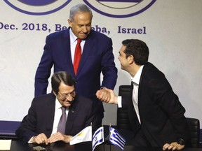 Israeli Prime Minister Benjamin Netanyahu, center, Greek Prime Minister Alexis Tsipras, right, and Cyprus' President Nicos Anastasiades meet during the 5th trilateral summit with Greece and Cyprus in Beersheba, Israel, Thursday, Dec. 20, 2018.
