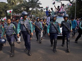 Bangladeshi policemen escort Bangladesh Awami League party election rally in Dhaka, Bangladesh, Thursday, Dec. 27, 2018. Bangladesh heads for the 11th National Parliamentary Election on Dec. 30, amid opposition allegations that thousands of its leaders and activists have been arrested to weaken them. But authorities say the arrests are not politically motivated and the opposition is trying to create chaos ahead of elections.