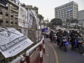 Bangladesh police's elite Rapid Action Battalion (RAB) personnel patrol on motorcycles ahead of the general elections in Dhaka, Bangladesh, Friday, Dec. 28, 2018.