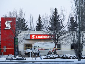 Police investigate the scene of a suspected bank robbery with an explosion that sent two guards to hospital in Edmonton, Alta., on Thursday, December 13, 2018.