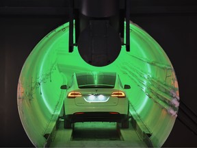 A modified Tesla Inc. Model X enters the tunnel at an unveiling event for the Boring Co. Hawthorne test tunnel in Hawthorne, California, U.S., on Tuesday, Dec. 18, 2018.