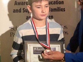 Joshua Trump is presented with a bravery medal by Teach Anti-Bullying.