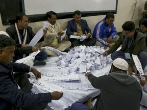 Bangladeshi election officials count ballots at a polling station after voting ended in Dhaka on December 30, 2018. - Bangladesh Prime Minister Sheikh Hasina appeared headed for a landslide win in a general election on December 30 that was marred by clashes between rival supporters that killed 14 people and opposition claims of rigged voting.