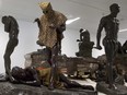 A sculpture called the 'Leopard Man,' second left, is stored with others in a cavernous room at the Africa Museum in Tervuren, Belgium, Friday, Aug. 3, 2018.
