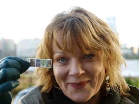 British actress Samantha Bond, Miss Moneypenny in some of the James Bond movies, holds up 07 January 2008 the new British Royal mail set of stamps to commemorate the centenary of the birth of Ian Fleming, the author of the James Bond novels. The London photocall was a preview for the release of the stamps, set for 08 January 2008.