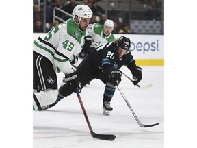 Dallas Stars' Roman Polak, left, and San Jose Sharks' Marcus Sorensen (20) fight for the puck during the first period of an NHL hockey game Thursday, Dec. 13, 2018, in San Jose, Calif.