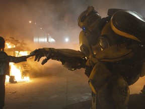 This image released by Paramount Pictures shows Hailee Steinfeld as Charlie and Bumblebee in a scene from "Bumblebee." (Paramount Pictures via AP)