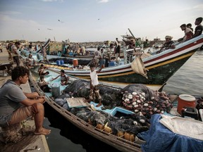 FILE - In this Sept. 29, 2018 file photo, fishermen rest on their boats before fishing at the main fishing port, in Hodeida, Yemen. Officials in Yemen said a cease-fire took effect at midnight Monday, Dec. 18, 2018, in the Red Sea port of Hodeida after intense fighting between government-allied forces and Shiite rebels erupted shortly before the U.N.-brokered truce. Yemen's civil war, in which a Saudi-led coalition is fighting on the government's side against the rebels, has pushed much of the country to the brink of famine.