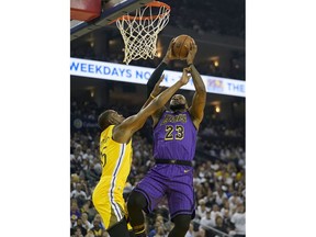 Los Angeles Lakers forward LeBron James (23) shoots over Golden State Warriors forward Kevin Durant (35) during the first half of an NBA basketball game Tuesday, Dec. 25, 2018, in Oakland, Calif.