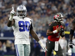 Dallas Cowboys defensive end DeMarcus Lawrence (90) celebrates as Tampa Bay Buccaneers quarterback Jameis Winston shouts in the direction of an official after throwing an incomplete pass in the second half of an NFL football game in Arlington, Texas, Sunday, Dec. 23, 2018.