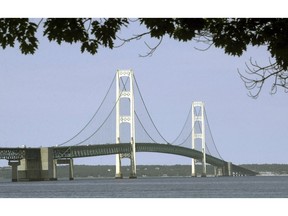 FILE - This July 19, 2002, file photo, shows the Mackinac Bridge that spans the Straits of Mackinac from Mackinaw City, Mich. Gov. Rick Snyder has signed legislation Wednesday, Dec. 12, 2018, establishing a panel to oversee a hotly disputed tunnel that will house an oil pipeline beneath the waterway linking Lake Huron and Lake Michigan. Snyder acted Wednesday, a day after the Republican-dominated Michigan Legislature gave the bill final approval.
