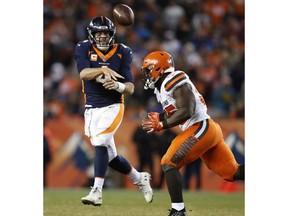 Denver Broncos quarterback Case Keenum (4) scrambles as Cleveland Browns outside linebacker Genard Avery (55) pursues during the second half of an NFL football game, Saturday, Dec. 15, 2018, in Denver.