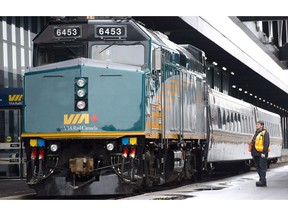 A VIA Rail employee stands on the platform next to a F40 locomotive at the train station in Ottawa on December 3, 2012.