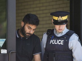 Truck driver Jaskirat Sidhu walks out of provincial court after appearing for charges due to the Humboldt Broncos bus crash in Melfort, Sask., on July 10, 2018. The case of a Calgary truck driver charged in April's Humboldt Broncos bus crash has been adjourned until the new year. Jaskirat Singh Sidhu is charged with 16 counts of dangerous driving causing death and 13 more of dangerous driving causing bodily harm.