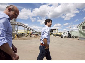 Prime Minister Justin Trudeau, right and Edmonton member of parliament, Randy Boissonnault visit the Kinder Morgan terminal in Edmonton on Tuesday June 5, 2018. Trudeau says he is overhauling how Canada assesses big energy projects in order to get Canada to the point where new projects can get built without the government having to buy them to make that happen.