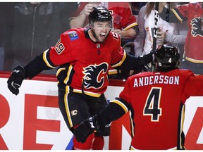 Calgary Flames' Alan Quine, left, celebrates his goal with teammate Rasmus Andersson during third period NHL hockey action against the Nashville Predators, in Calgary, Saturday, Dec. 8, 2018. The Flames bounced from humiliation into the race for first place in the NHL's Western Conference in a few short weeks. Since an embarrassing 9-1 loss at home Oct. 25 at the hands of the Pittsburgh Penguins, the Flames have gone 15-5-2. A 32-point haul in that span is second only to the Tampa Bay Lightning (36).