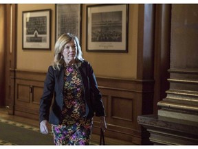 Ontario's Health Minister Christine Elliot walks a corridor in the Queens Park Legislature in Toronto, on Tuesday October 30, 2018. The association representing Ontario midwives is "very disappointed" about the province's decision to cut funding to the birth practitioners' regulatory college, saying the already underpaid workers will likely see a jump in professional fees to help cover the shortfall.