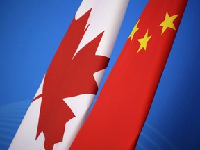 Flags of Canada and China are placed for the first China-Canada economic and financial strategy dialogue in Beijing, China, Monday, Nov. 12, 2018. Experts say the detaining of an Alberta woman over what authorities call employment issues could signal a ramping up of low-level harassment for Canadians living in China.