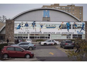 Toronto police respond to a bomb threat at St. Michael's College School, in Toronto on Monday, Nov. 19, 2018. The interim president of a Roman Catholic all-boys school rocked by student-on-student abuse allegations said on Thursday that only the football program was cancelled for next year because of the particular dynamics on those teams.