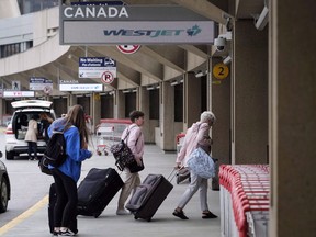 Travellers arrive at the Calgary Airport in Calgary, Alta., Thursday, May 10, 2018. Parts of the Calgary International Airport were locked down on the busiest pre-Christmas travel day because of a gun scare that turned out to be unfounded.