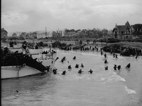 The Royal Canadian Mint is being given the green light to create two commemorative coins next year to mark the 75th anniversary of D-Day. Bernieres-sur-Mer, France; June 6,1944--SECOND WORLD WAR--View looking east along 'Nan White' Beach, showing personnel of the 9th Canadian Infantry Brigade landing from LCI(L) 299 of the 2nd Canadian (262nd RN) Flotilla on D-Day.(CP PHOTO) 1998 ( National Archives of Canada-Gilbert Alexandre Milne ) PA-137013 *MANDATORY CREDIT*