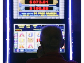 A man plays at a video lottery terminal at Tioga Downs, in Nichols, N.Y., in a Thursday, Oct. 16, 2014 file photo. An intriguing court case that alleges Crown-owned video lottery terminals are inherently deceptive and violate the Crimal Code has reached a critical milestone in Newfoundland and Labrador.THE CANADIAN PRESS/AP/Mike Groll